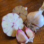 garlic cut open and whole with a pink tinge on the cloves